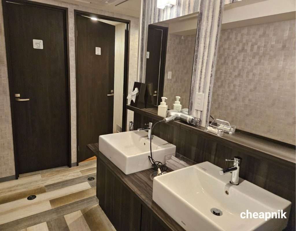 The shower, toilet, and sink area at Hotel Tomariya Ueno in Tokyo