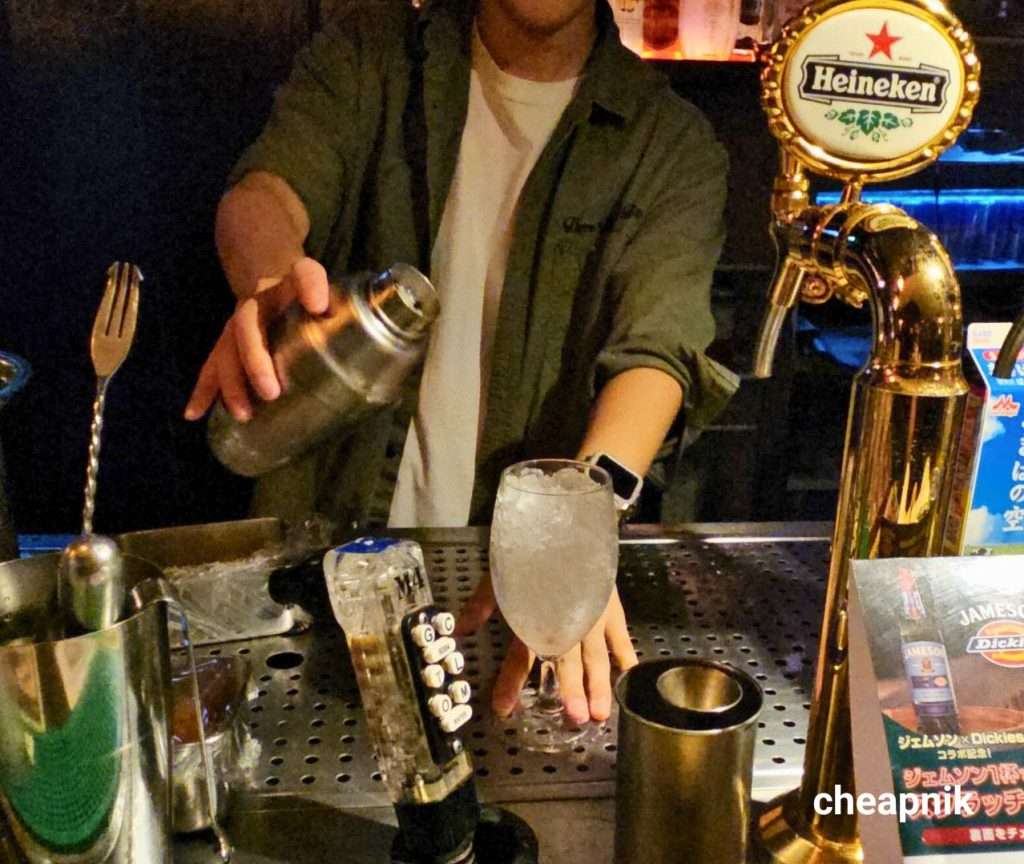 Bartender pouring out drinks at 300 Bar Ginza.