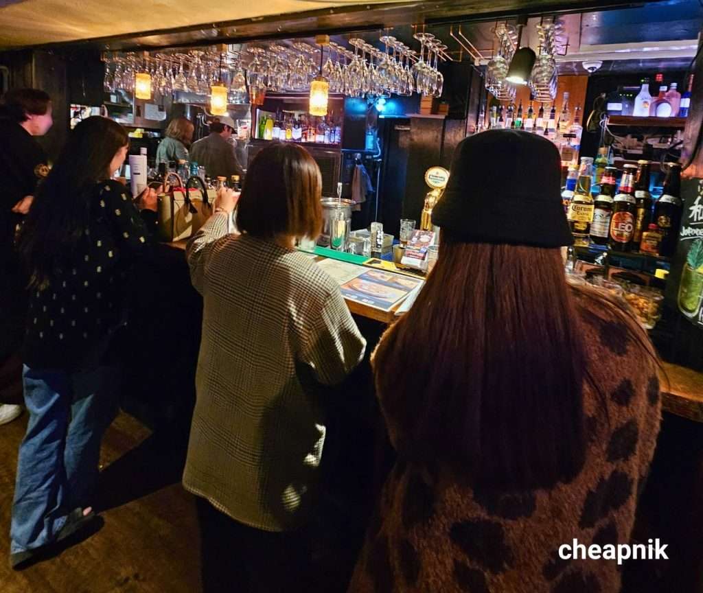 Customers getting drinks at the bar.