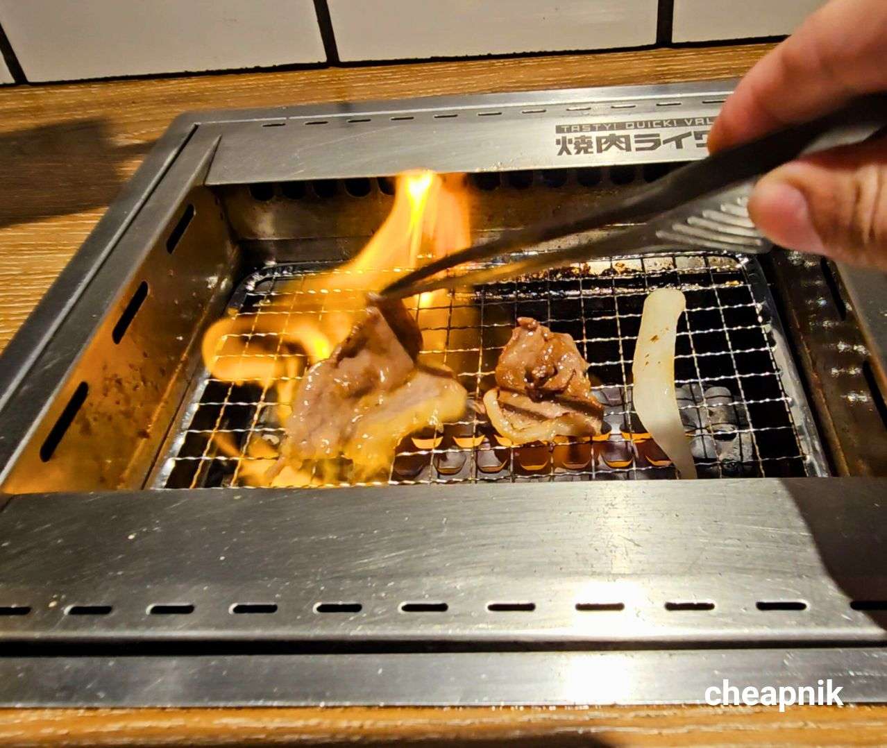 Grilling the meat over fire at Yakiniku Like