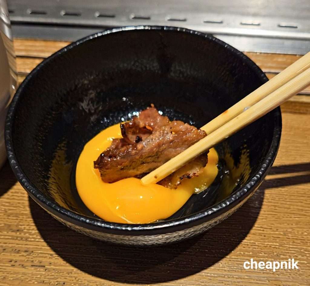 Yakiniku grilled meat dipped on fresh egg for richness at Yakiniku Like