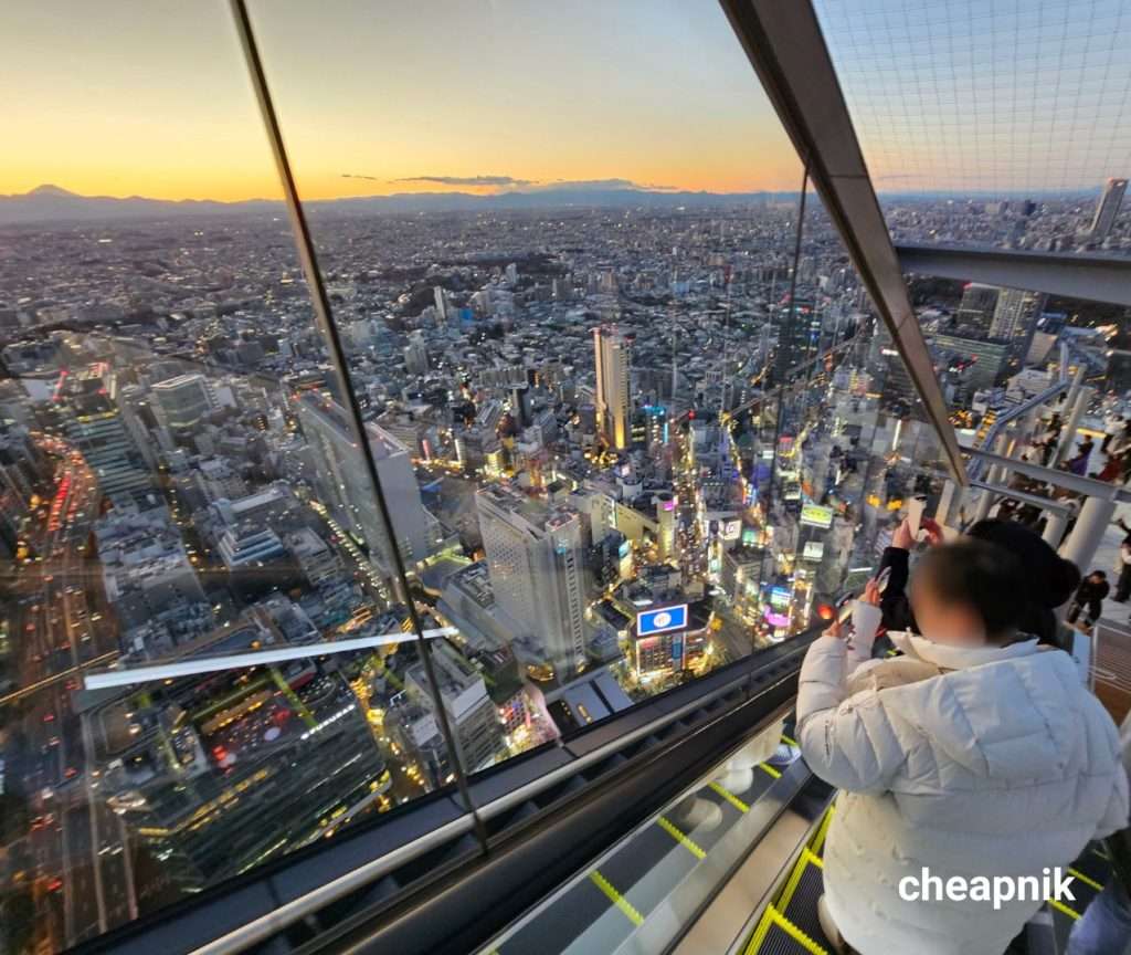 Sunset view from the glass escalator at the rooftop of Shibuya Sky