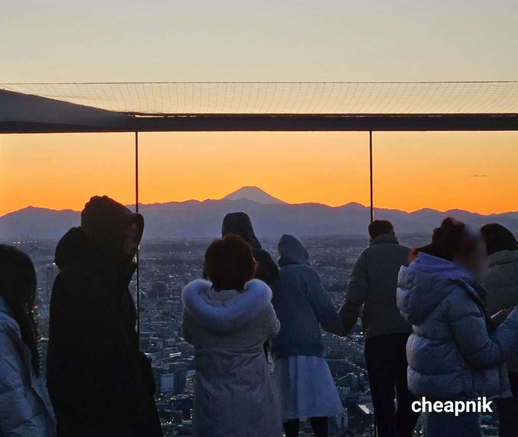 Visitors looking at the view of Mt. Fuji from Shibuya Sky