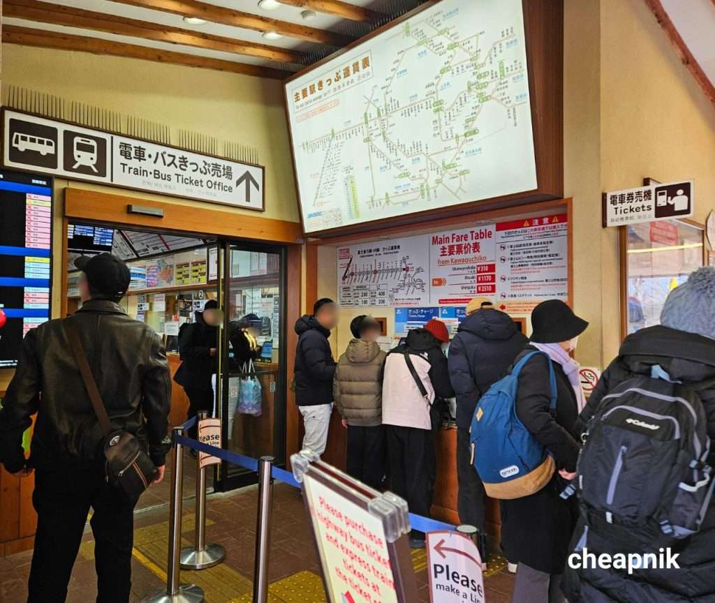 Passengers buying train tickets at Kawaguchiko Station