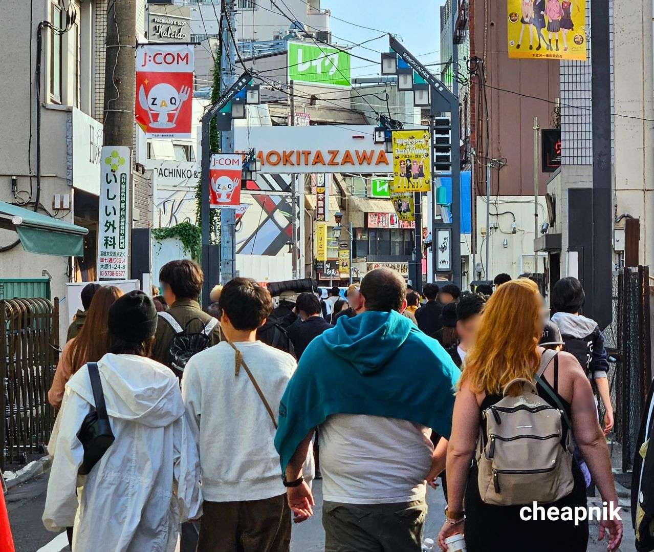 Tourists walking along a shopping street in Shimokitazawa