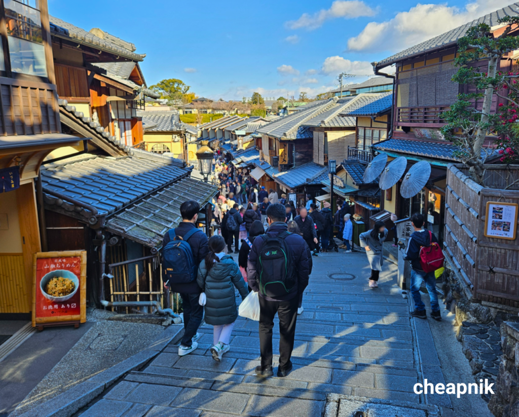 Crowd of tourists walk along the famous Ninenzaka Street in Kyoto.